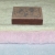 Сравнение толщины ткани со спичечным коробком: зеленое в два слоя, розовое - в 4 слоя свернуто.
